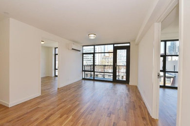 Mid-sized minimalist open concept and formal medium tone wood floor living room photo in New York with beige walls, no fireplace and no tv