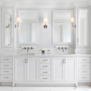 Bathroom - large transitional master white tile and marble tile white floor and marble floor bathroom idea in Detroit with recessed-panel cabinets, white cabinets, gray walls, an undermount sink, white countertops, a two-piece toilet, marble countertops and a hinged shower door