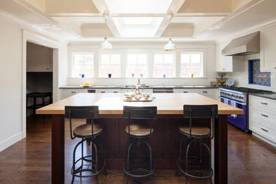 Inspiration for a large cottage l-shaped dark wood floor open concept kitchen remodel in San Francisco with an undermount sink, recessed-panel cabinets, white cabinets, wood countertops, blue backsplash, subway tile backsplash, colored appliances and an island