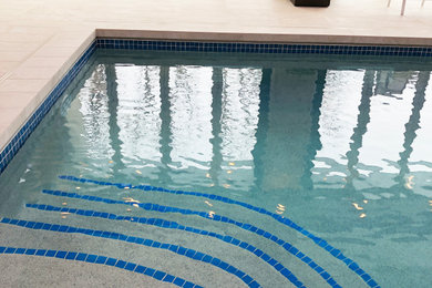 Pool - large contemporary rectangular pool idea in Cedar Rapids
