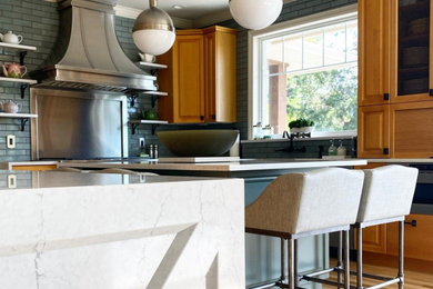 Inspiration for a mid-sized transitional u-shaped eat-in kitchen remodel in Vancouver with raised-panel cabinets, quartz countertops, blue backsplash, brick backsplash, stainless steel appliances, an island and white countertops