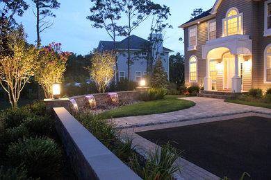 Inspiration for a large beach style front yard full sun driveway in New York with concrete pavers.