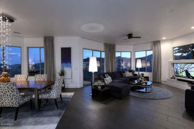 Large trendy open concept porcelain tile living room photo in Phoenix with white walls, no fireplace and a wall-mounted tv