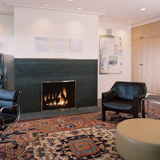 This is an example of a medium sized modern study in San Francisco with beige walls, dark hardwood flooring, a standard fireplace, a tiled fireplace surround and a freestanding desk.