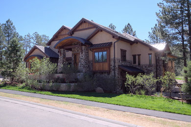 This is an example of a mid-sized country one-storey beige exterior in Denver with mixed siding.
