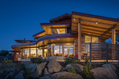 Photo of a contemporary two-storey exterior in Denver with stone veneer.