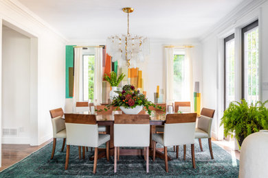 Example of a trendy medium tone wood floor and brown floor dining room design in Toronto with multicolored walls