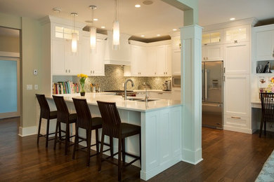 Eat-in kitchen - mid-sized transitional u-shaped dark wood floor and brown floor eat-in kitchen idea in Vancouver with a double-bowl sink, shaker cabinets, white cabinets, quartzite countertops, multicolored backsplash, mosaic tile backsplash, stainless steel appliances and a peninsula