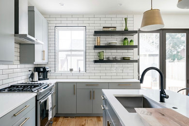 Example of a country kitchen design in Denver with white backsplash