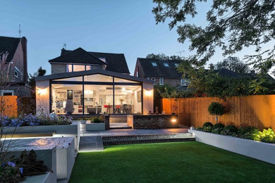 This is an example of a medium sized contemporary formal garden for summer in Hertfordshire.