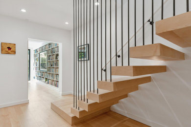 Mid-sized tuscan wooden floating open and metal railing staircase photo in San Francisco