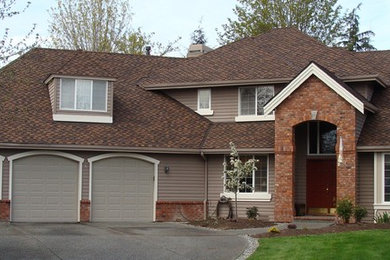 Design ideas for a large traditional two-storey grey exterior in Seattle with wood siding and a hip roof.