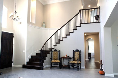 Mid-sized elegant wooden curved wood railing staircase photo in San Diego with wooden risers
