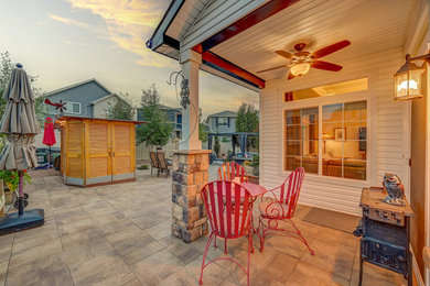 Inspiration for a mid-sized modern backyard concrete paver patio remodel in Denver with a pergola