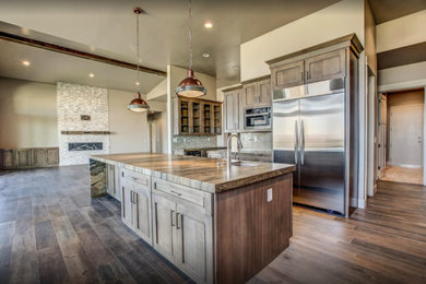 Open concept kitchen - mid-sized craftsman galley dark wood floor and brown floor open concept kitchen idea in Other with an undermount sink, shaker cabinets, dark wood cabinets, granite countertops, beige backsplash, porcelain backsplash, stainless steel appliances and an island