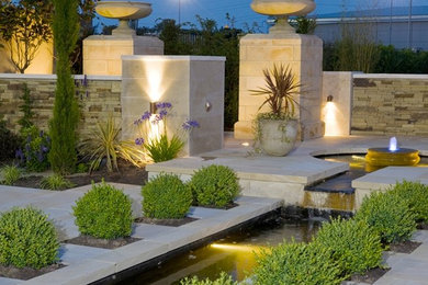 Backyard formal garden in Perth with natural stone pavers.