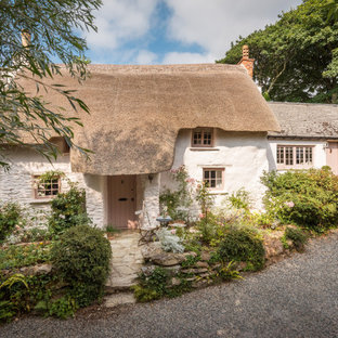 This is an example of a medium sized shabby-chic style two floor detached house in Cornwall with a pink house and a pitched roof.