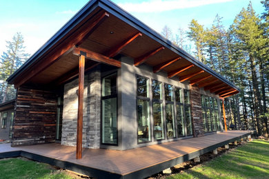 Large modern brown two-story concrete fiberboard and clapboard house exterior idea in Portland with a brown roof