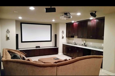 Large 1960s look-out carpeted, beige floor and tray ceiling basement photo in Other with a home theater and beige walls