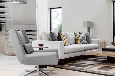 Example of a large trendy open concept ceramic tile and white floor living room design in Orange County with white walls