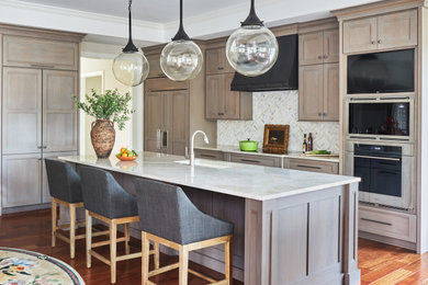 Mid-sized transitional l-shaped medium tone wood floor, brown floor and tray ceiling eat-in kitchen photo in Chicago with an undermount sink, flat-panel cabinets, light wood cabinets, beige backsplash, stainless steel appliances, an island and beige countertops