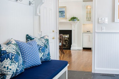 Mid-sized elegant gray floor mudroom photo in Cleveland with white walls