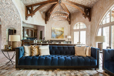 Inspiration for a huge transitional open concept medium tone wood floor family room remodel in Houston with beige walls and a wall-mounted tv
