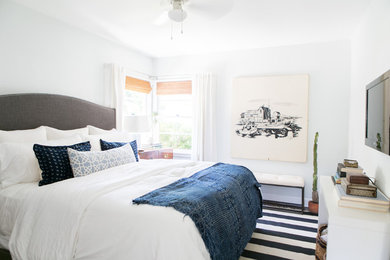 Beach style master dark wood floor bedroom photo in Los Angeles with white walls