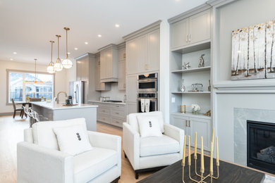 Inspiration for a mid-century modern light wood floor and beige floor living room remodel in Calgary with beige walls, a standard fireplace and a stone fireplace