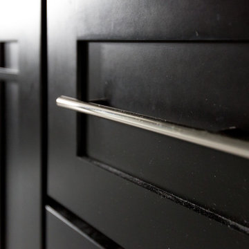 White Marble Bathroom with Black Cabinets
