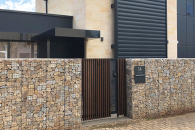 Photo of a modern front yard garden in Adelaide with with rock feature.