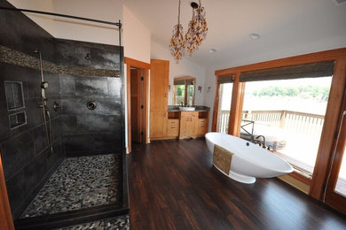 Large minimalist master gray tile and stone tile dark wood floor bathroom photo in Other with raised-panel cabinets, light wood cabinets, white walls, a vessel sink and granite countertops
