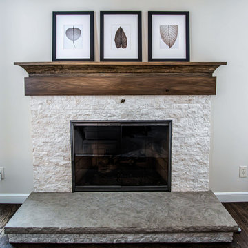 Two Tone Kitchen with Floating Shelves and Island Seating and Updated Fireplace