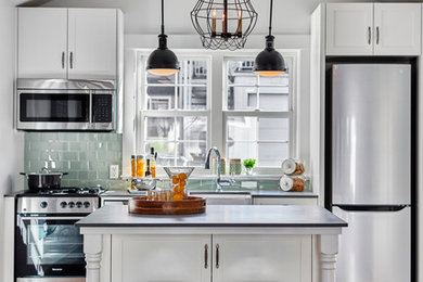 Inspiration for a small transitional kitchen in Vancouver with green splashback and with island.
