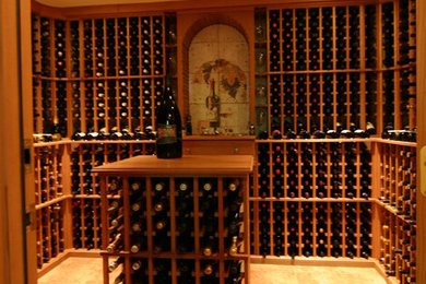 Photo of a mid-sized country wine cellar in New York with ceramic floors and storage racks.