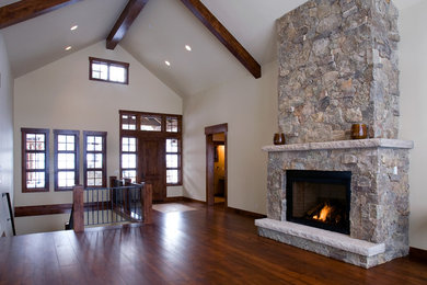 Example of a mid-sized classic formal and open concept dark wood floor living room design in Denver with white walls, a standard fireplace and a stone fireplace