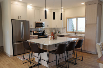 Inspiration for a mid-sized transitional l-shaped medium tone wood floor and brown floor eat-in kitchen remodel in Other with an undermount sink, shaker cabinets, light wood cabinets, quartz countertops, white backsplash, stainless steel appliances, an island and white countertops
