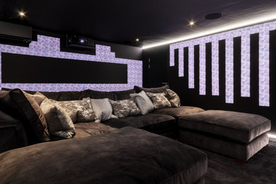 This is an example of a large modern home cinema in Essex.