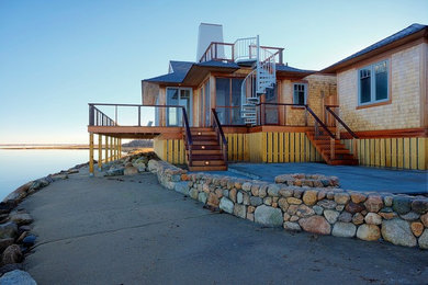 Inspiration for a mid-sized coastal one-story wood house exterior remodel in Boston with a hip roof and a shingle roof