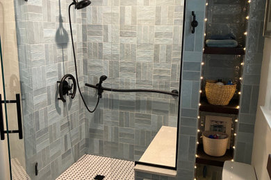 Example of a mid-sized mid-century modern master blue tile and ceramic tile porcelain tile, brown floor and double-sink shower bench design in Other with shaker cabinets, blue cabinets, a bidet, beige walls, a vessel sink, a hinged shower door, white countertops and a floating vanity