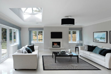 This is an example of a modern living room in Sacramento with white walls, a standard fireplace and a wall-mounted tv.