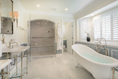 Design ideas for an expansive traditional master bathroom in Los Angeles with open cabinets, a freestanding tub, an alcove shower, gray tile, stone tile, white walls, marble floors, a pedestal sink and solid surface benchtops.