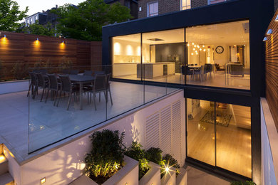 Photo of a mid-sized contemporary backyard patio in London.