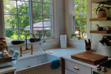 Mid-sized elegant beige floor kitchen pantry photo in Bridgeport with a drop-in sink, white backsplash and an island