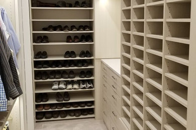 Walk-in closet - large contemporary men's carpeted and beige floor walk-in closet idea in Omaha with flat-panel cabinets and light wood cabinets