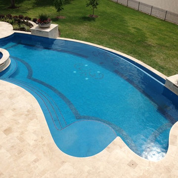 Traditional curved pool with custom mosaic design