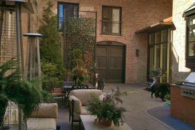 Design ideas for a traditional courtyard patio in Chicago with stamped concrete and no cover.