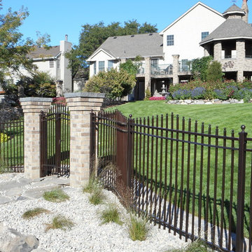 Curved wrought iron fence with gates