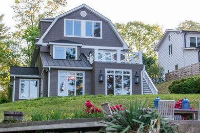 Example of a large arts and crafts gray two-story wood house exterior design in Baltimore with a shingle roof