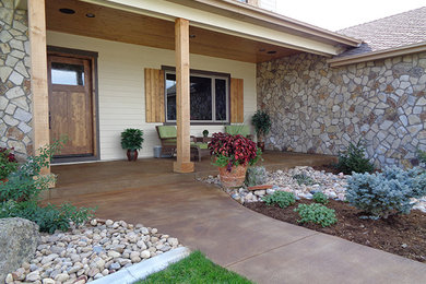 Mid-sized classic concrete front porch idea in Denver with a roof extension